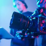 Camera crew with professional camera in studio